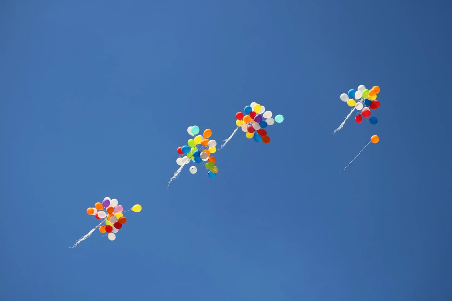 Balloons floating away in the air
